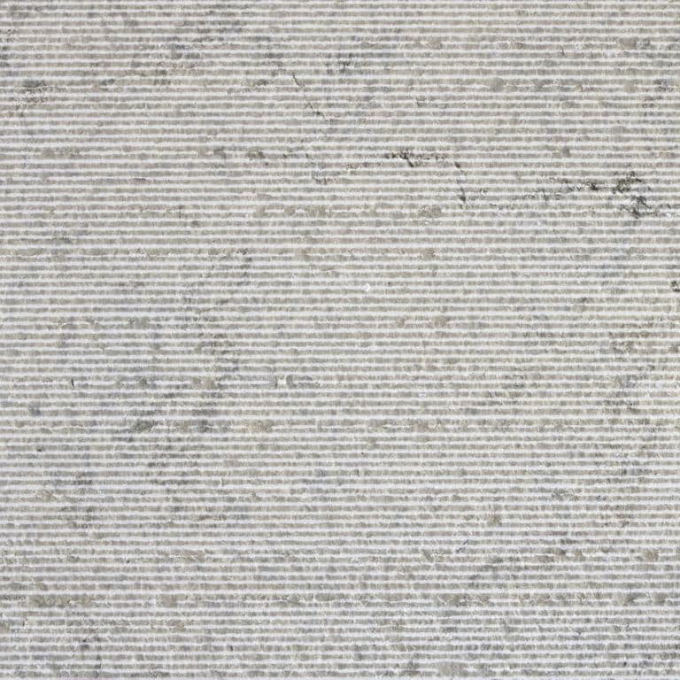 Color/Finish variation image for Sky Prima Limestone. The surface finish shown is chiseled. The dominant color shown is gray; with beige and white secondaries. The color mix creates a cool feeling. Regular, linear and cloudy color patterns.