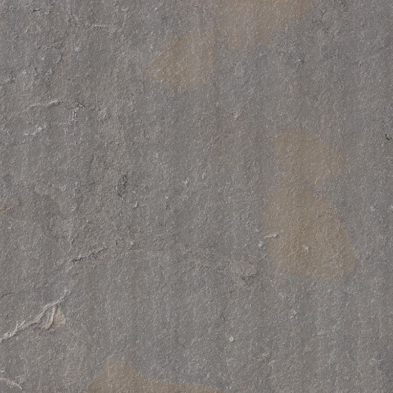 Color/Finish variation image for Limestone - Portuguese Amaza Estrema. The surface finish shown is flamed. The dominant color shown is gray; with brown, green and purple secondaries. The color mix creates a cool feeling. Random, blotched and cloudy color patterns. Contains mineral inclusions.