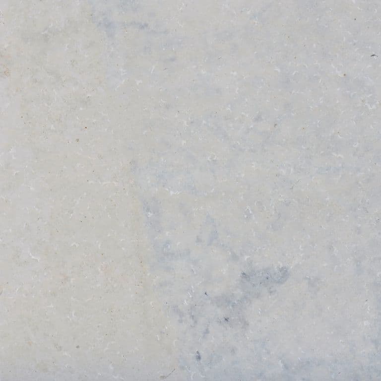 Color/Finish variation image for Valamaza Limestone. The surface finishes shown are brushed and flamed. Dominant colors shown are beige, gray and white; with pink and purple secondaries. Exhibits "movement" and the color mix creates a cool feeling. Blotched and cloudy color patterns.
