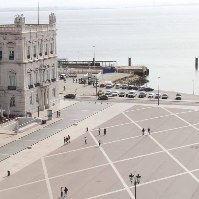 Feature image for Limestone - Portuguese Liacado. The image shows this material being used for patio pavers and public area. The dominant color shown is gray; with beige, pink, purple, white, tan and cream secondaries. The color mix creates a warm feeling. Solid color pattern.