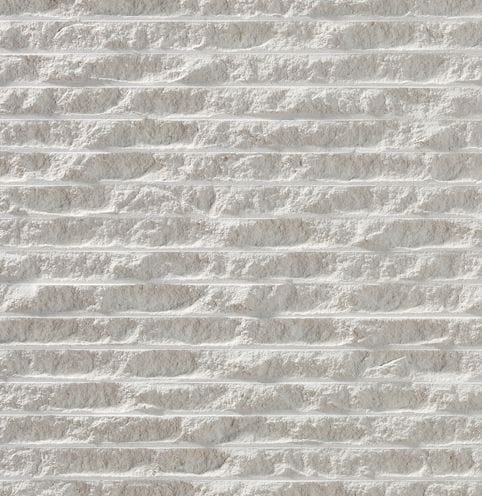 Color/Finish variation image for Royal White Limestone. The surface finish shown is chiseled. Dominant colors shown are gray and white; with beige, pink and cream secondaries. Exhibits "movement" and the color mix creates a cool feeling. Regular, linear, swirled and cloudy color patterns.