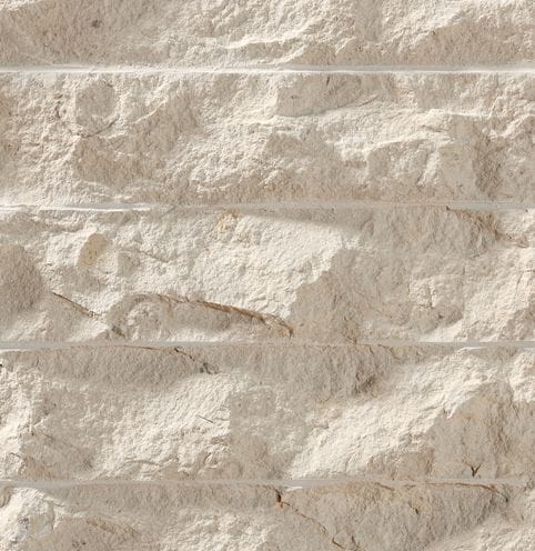 Color/Finish variation image for Cremcar Limestone. The surface finish shown is chiseled. Dominant colors shown are beige and tan; with brown, gray, orange/rust and cream secondaries. Exhibits "movement" and the color mix creates a warm feeling. Regular and cloudy color patterns.