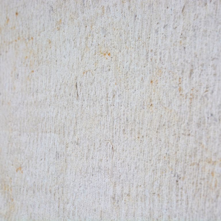 Color/Finish variation image for Cremcar Limestone. The surface finish shown is chiseled. Dominant colors shown are gray and white; with a beige secondary. Exhibits "movement" and the color mix creates a cool feeling. Regular and cloudy color patterns.