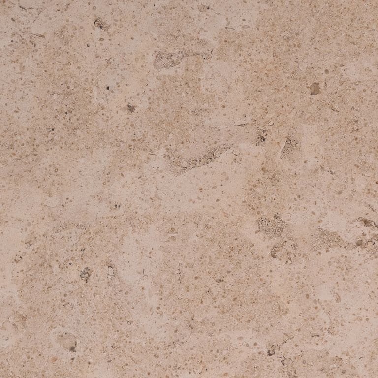 Swatch image for Portuguese Pacific Beige Limestone. The surface finish shown is honed. The dominant color shown is tan; with an orange/rust secondary. Exhibits "movement" and the color mix creates a warm feeling. Blotched and random color patterns.