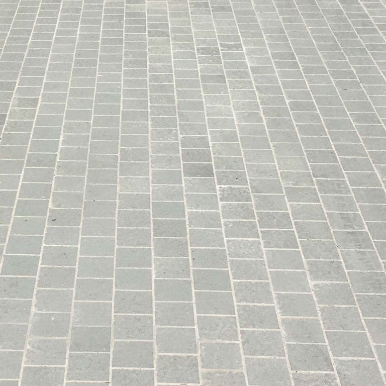 The image shows this material being used for driveway pavers and patio pavers.