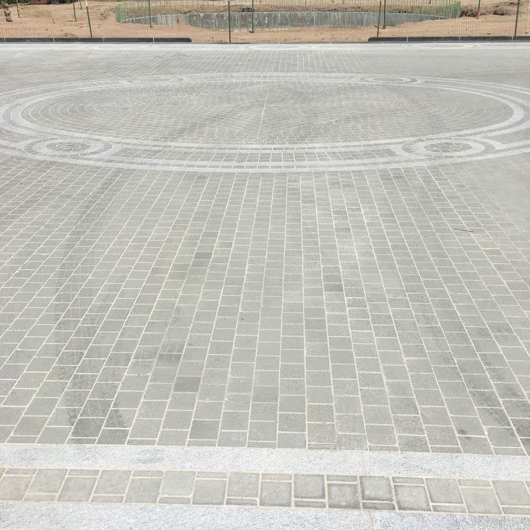 Application image for Bluestone - Italian. The image shows this material being used for patio pavers and public area. The dominant color shown is gray.