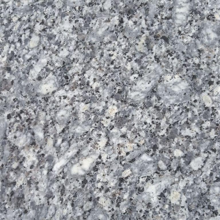 Color/Finish variation image for Colonial Blue Granite. The surface finish shown is polished. The dominant color shown is gray; with blue and white secondaries. The color mix creates a cool feeling. Coarse speckled and blotched color patterns.