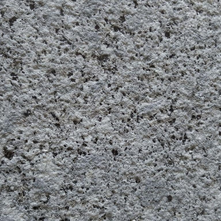 Color/Finish variation image for Colonial Blue Granite. The surface finish shown is sand blasted. The dominant color shown is gray. The color mix creates a cool feeling. Regular color pattern.