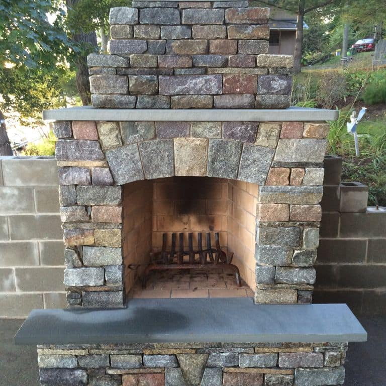 Application image for Granite - Adirondack. The image shows this material being used in an outdoor fire concepts application. The dominant color shown is gray. The color mix creates a warm feeling.