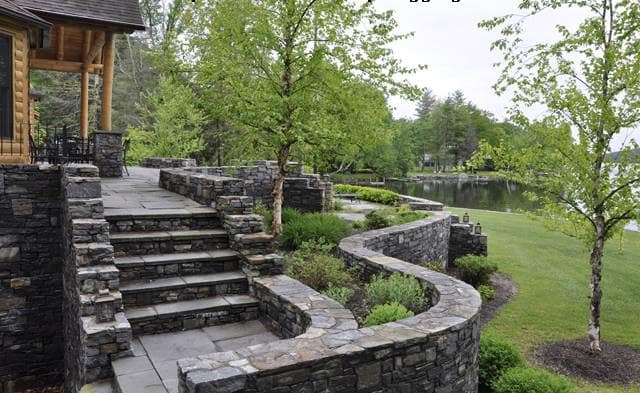 The image shows this material being used in a landscape wallstone application.