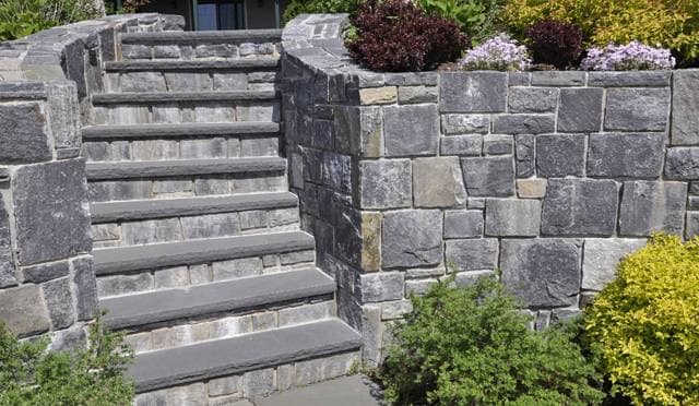 The image shows this material being used in a landscape wallstone application.