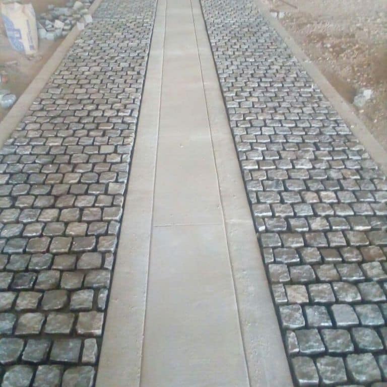 The image shows this material being used in a path pavers application.