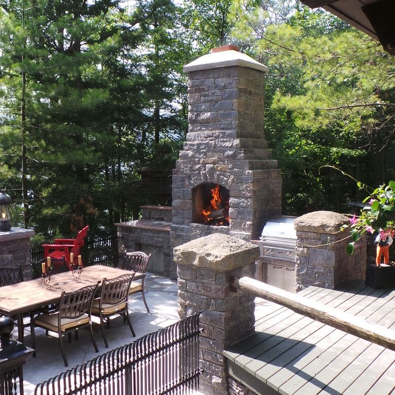 Application image for Granite - Hawthorne Granite. The image shows this material being used for outdoor fire concepts and thin veneer. The dominant color shown is gray.