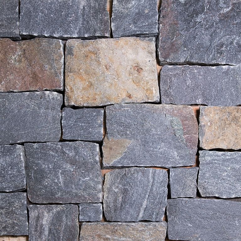 Close-up image for Saranac Granite. Dominant colors shown are blue and gray; with beige, brown, orange/rust, purple, white and tan secondaries. Exhibits "movement". Random, fine speckled, blotched, streaked and cloudy color patterns.