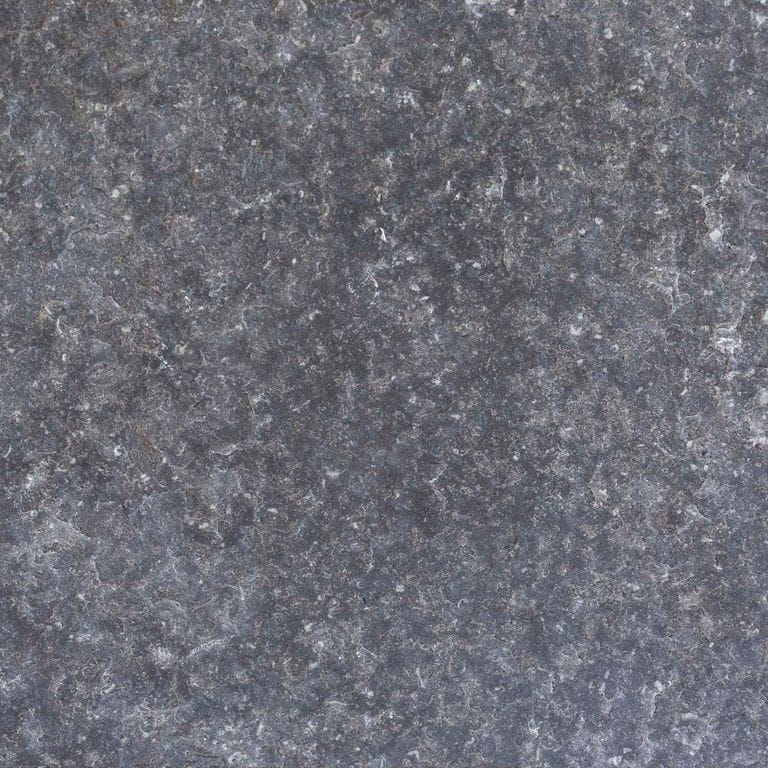 Color/Finish variation image for Northern Gray Limestone. The surface finishes shown are brushed and flamed. Dominant colors shown are blue, gray and purple; with brown and green secondaries. The color mix creates a cool feeling. Coarse speckled color pattern.