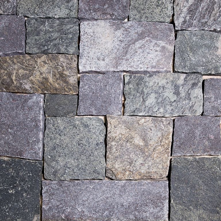 Close-up image for Lake George Granite. Dominant colors shown are blue, gray and purple; with beige, black, brown, green and white secondaries. Exhibits "movement". Random, speckled, fine speckled, blotched, streaked and cloudy color patterns.