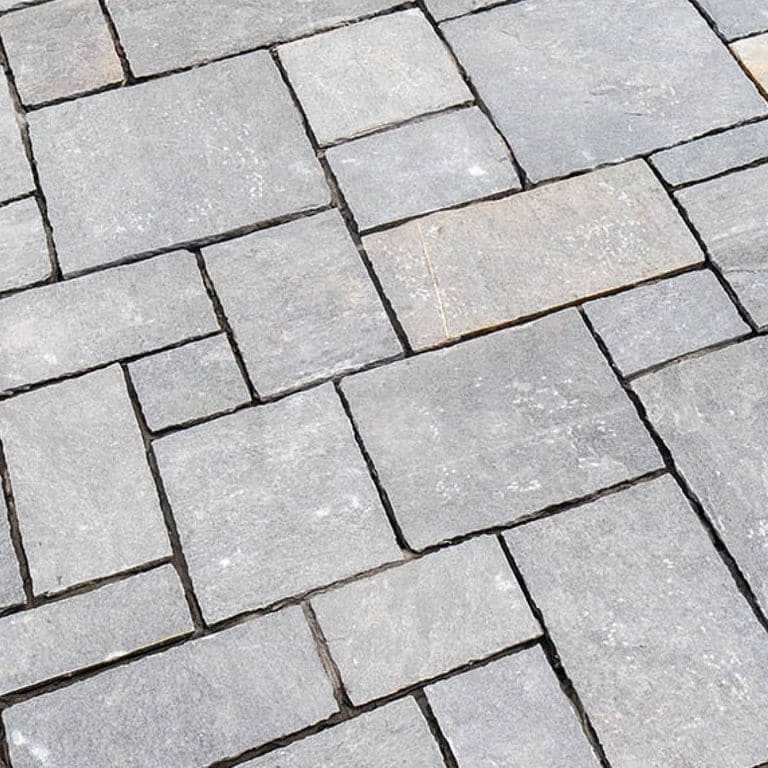The image shows this material being used in a patio pavers application.