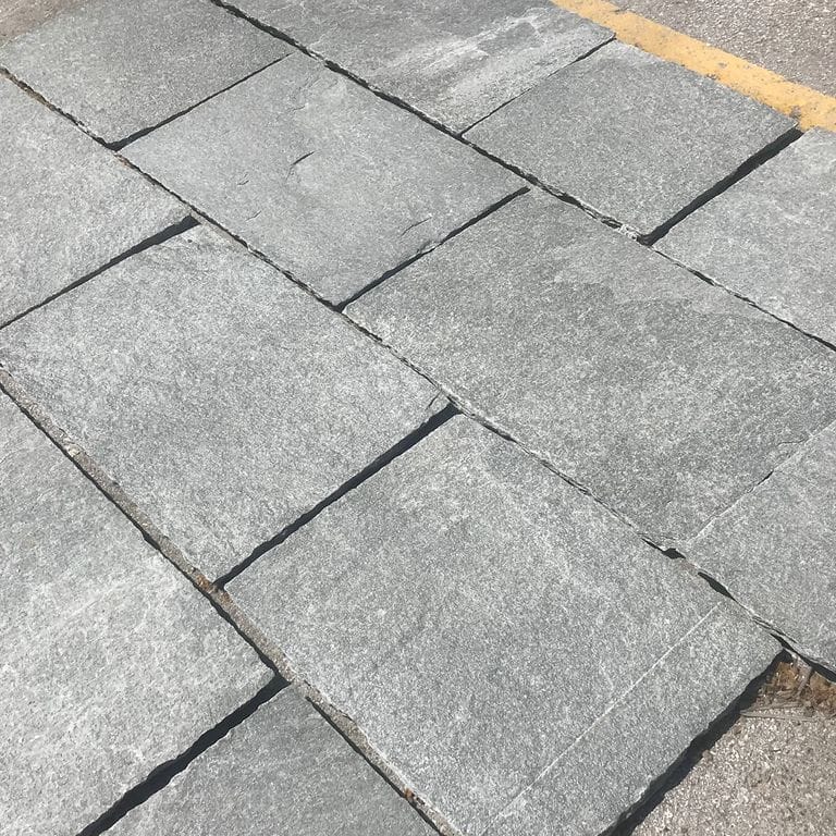 The image shows this material being used in a patio pavers application.