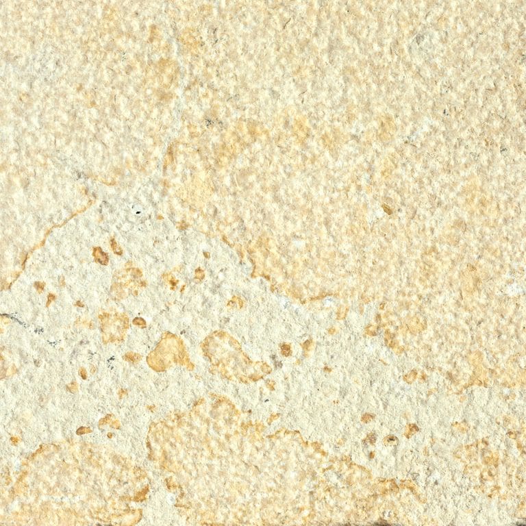 Feature image for Limestone - China Buff. Dominant colors shown are beige, orange/rust, yellow, tan and cream; with orange/rust and white secondaries. Exhibits "movement" and the color mix creates a warm feeling. Blotched color pattern. Contains mineral inclusions.