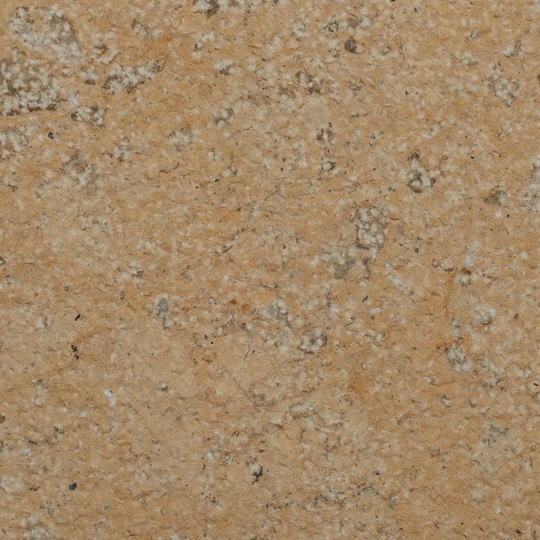 Color/Finish variation image for China Buff Limestone. The surface finish shown is bush hammered. Dominant colors shown are brown, yellow and tan. The color mix creates a warm feeling.