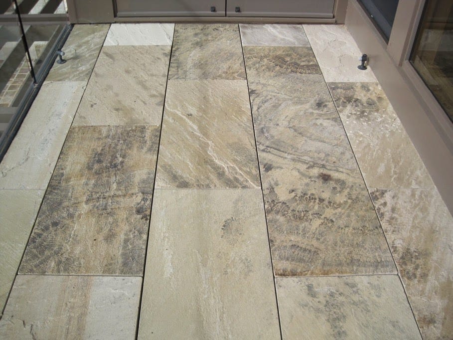 The image shows this material being used in a patio pavers application.