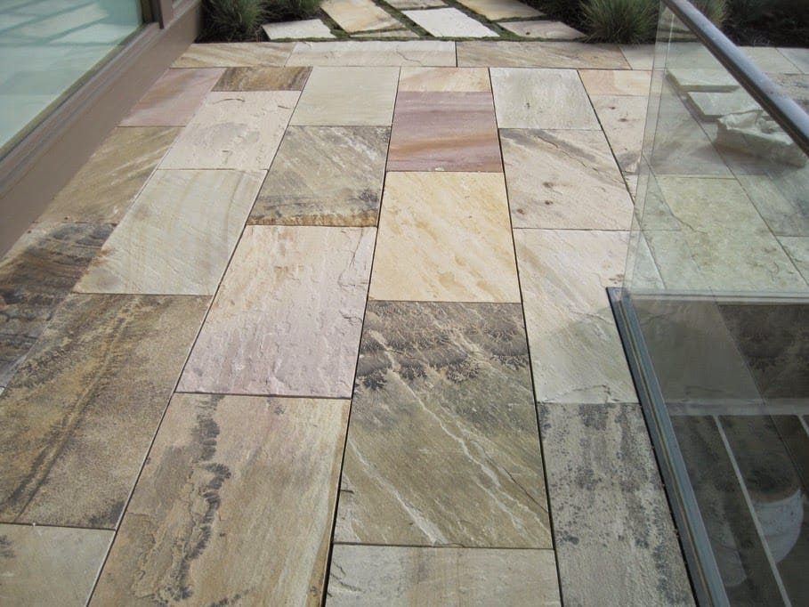 The image shows this material being used in a patio pavers application.