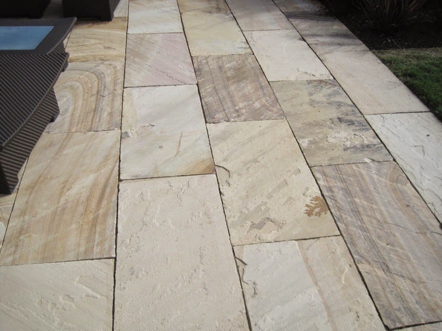 The image shows this material being used in a patio pavers application.