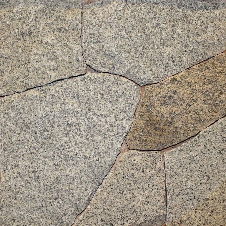 Close-up image for Dusty Rose Granite. The surface finish shown is natural. Dominant colors shown are gray and tan; with beige, brown and orange/rust secondaries. The color mix creates a warm feeling. Speckled color pattern.