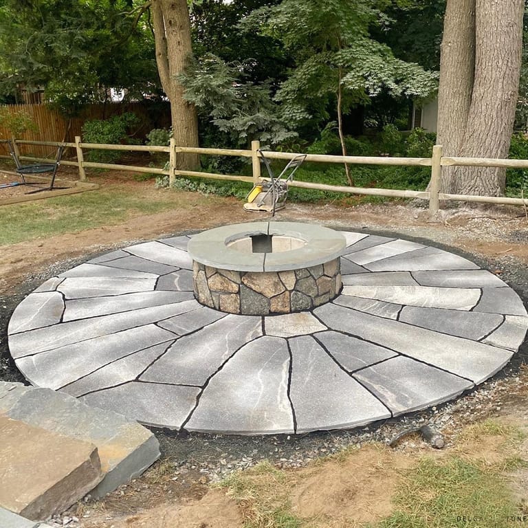Feature image for Fitzwilliam Granite. The image shows this material being used in a patio pavers application. The dominant color shown is gray; with beige, white and cream secondaries. Exhibits "movement" and the color mix creates a cool feeling. Random and veined color patterns.