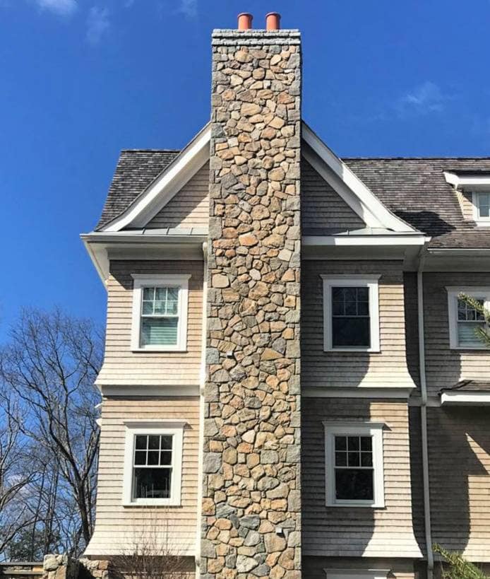 Application image for Fieldstone - Old New England Wall.. The image shows this material being used for thin veneer and chimney.