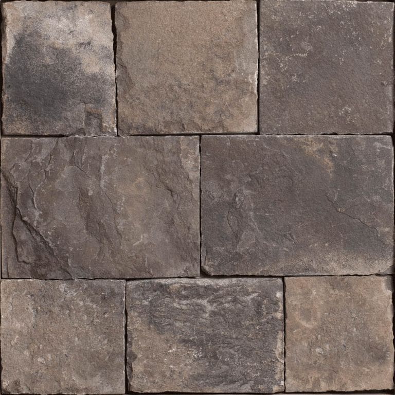 Close-up image for Fieldstone Dark. The surface finish shown is split-face. Dominant colors shown are brown, gray and purple; with green, orange/rust and tan secondaries. The color mix creates a warm feeling. Regular, blotched and swirled color patterns.