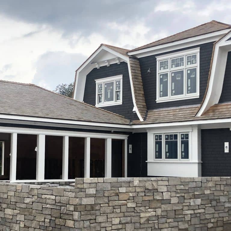 Application image for Harbor Mist Granite. The image shows this material being used for full bed veneer and thin veneer. The dominant color shown is gray. The color mix creates a warm feeling. Regular color pattern.