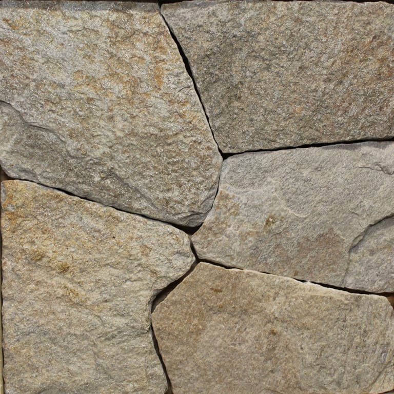 Close-up image for Colonial Tan Granite. The surface finish shown is natural. Dominant colors shown are brown and tan; with gray and orange/rust secondaries. Exhibits "movement" and the color mix creates a warm feeling. Speckled, blotched and cloudy color patterns.