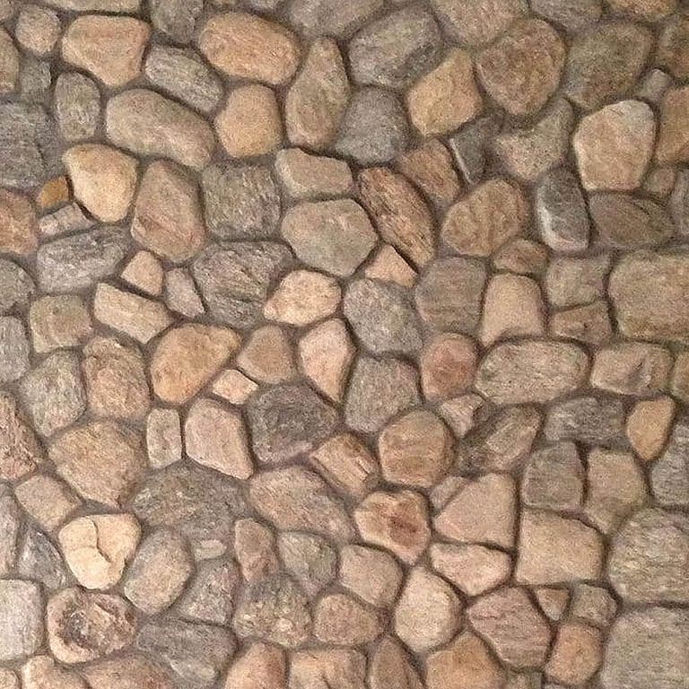 Close-up image for Cedar Creek River Rounds. The surface finish shown is natural. Dominant colors shown are brown, orange/rust and tan; with a beige secondary. The color mix creates a warm feeling. Regular color pattern.