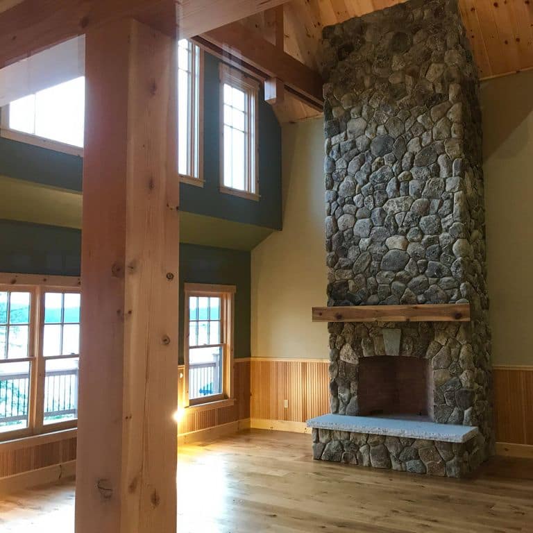 Application image for Fieldstone - Old New England Round. The image shows this material being used for fireplace hearth, thin veneer and interior cladding. The dominant color shown is brown. The color mix creates a warm feeling.