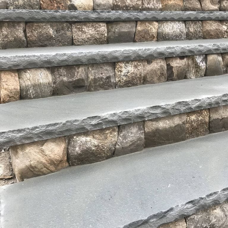 Application image for Fieldstone - Old New England Round.. The image shows this material being used for treads, full bed veneer and thin veneer.