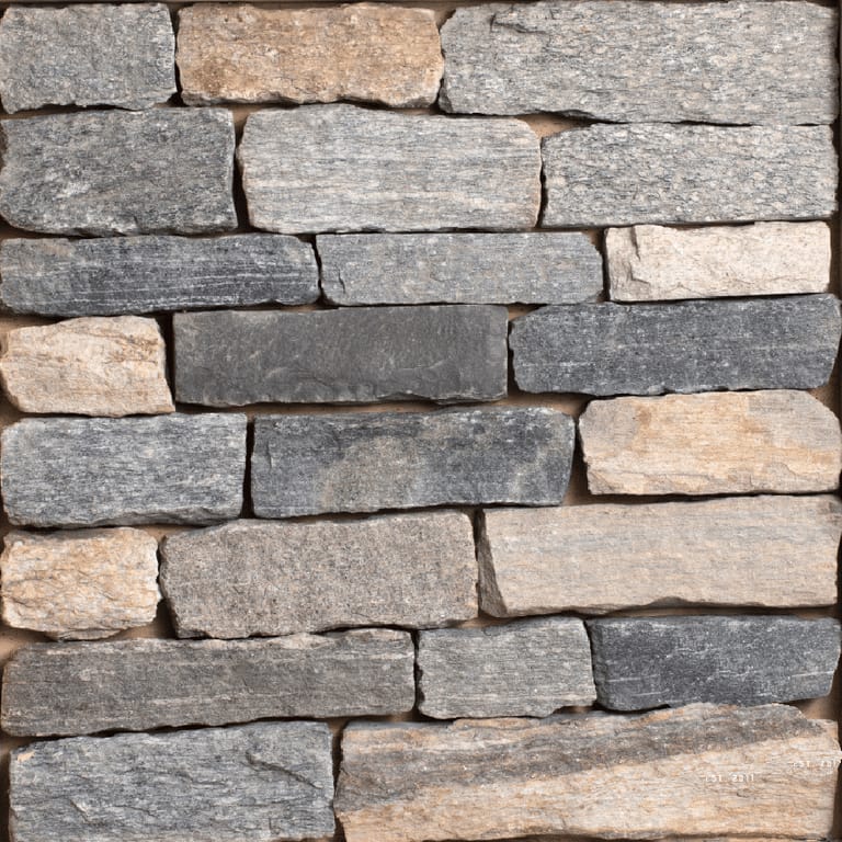 Close-up image for Split Fieldstone. The surface finish shown is split-face. The dominant color shown is gray; with beige, brown, green, orange/rust, purple, white, tan and cream secondaries. Exhibits "movement" and the color mix creates a warm feeling. Speckled and linear color patterns.
