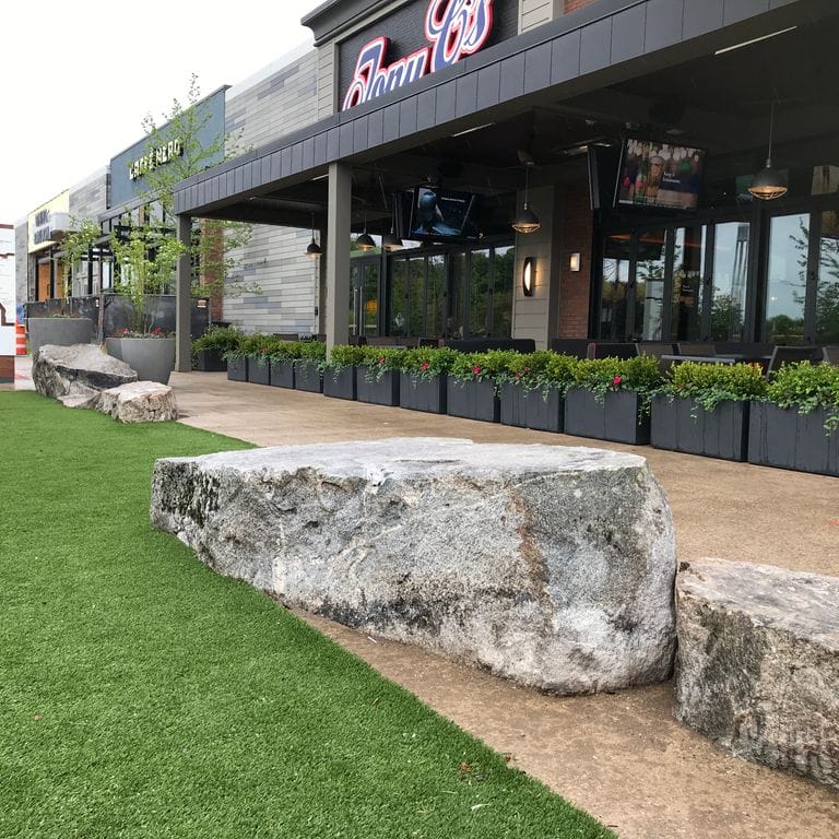The image shows this material being used for garden accents, seating &amp; benches and landscape boulders &amp; ledge. Dominant colors shown are gray and white; with beige and black secondaries.