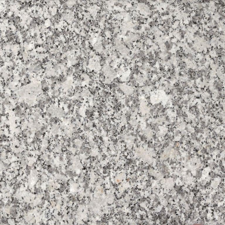 Best close-up image for Granite - Freshwater Pearl. The surface finish shown is flamed. The dominant color shown is gray; with beige, pink and cream secondaries. The color mix creates a cool feeling. Speckled color pattern. Contains some mica and mineral inclusions.