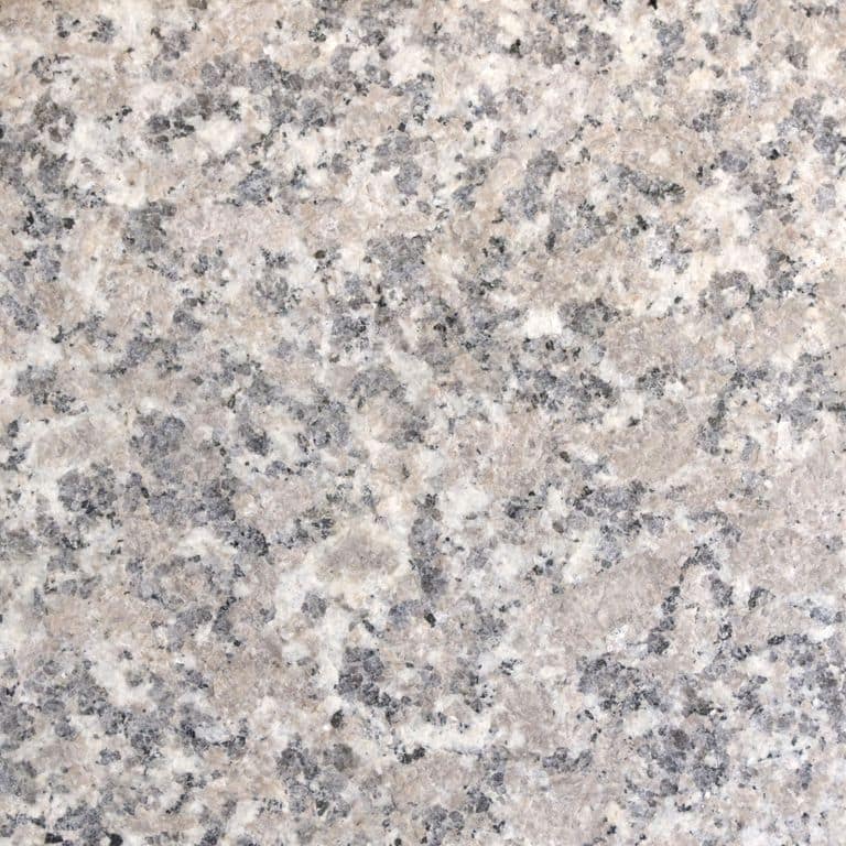 Color/Finish variation image for Deer Isle Granite. The surface finish shown is flamed. Dominant colors shown are beige, gray and pink. The color mix creates a cool feeling. Coarse speckled color pattern.