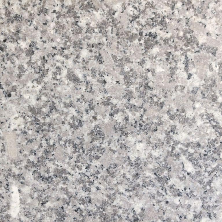 Swatch image for Deer Isle Granite. The surface finish shown is honed. Dominant colors shown are gray and pink; with beige, blue, pink, purple, white and cream secondaries. The color mix creates a cool feeling. Blotched and random color patterns. Contains some mica and mineral inclusions.