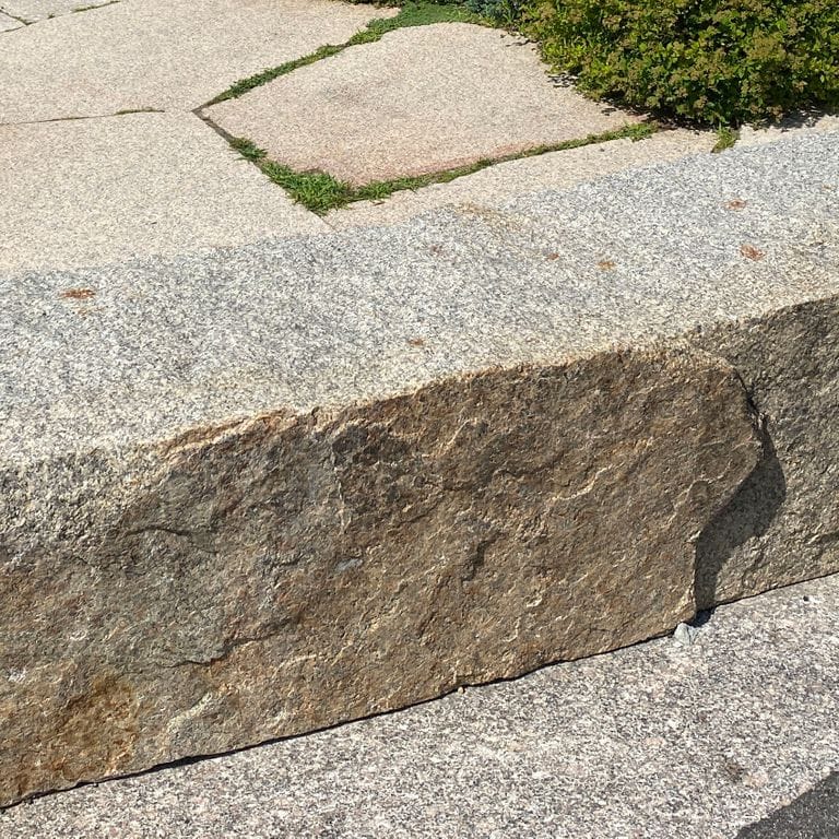 Application image for Deer Isle Granite. The image shows this material being used in a seating &amp; benches application. The surface finish shown is . Dominant colors shown are beige, gray, pink and tan. The color mix creates a warm feeling. Speckled color pattern.