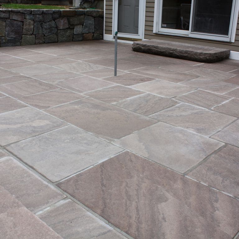 The image shows this material being used for patio pavers and monolithic steps.