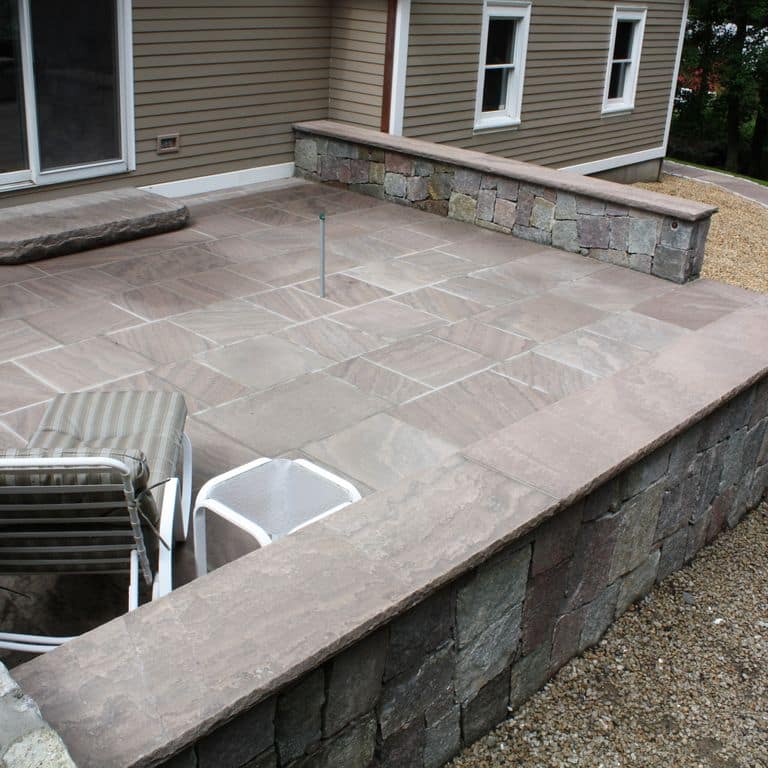 The image shows this material being used for wallstone cap, patio pavers and monolithic steps.