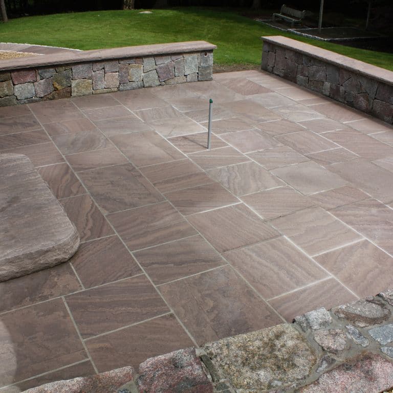 The image shows this material being used for wallstone cap, patio pavers and monolithic steps.
