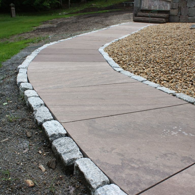 The image shows this material being used in a path pavers application.