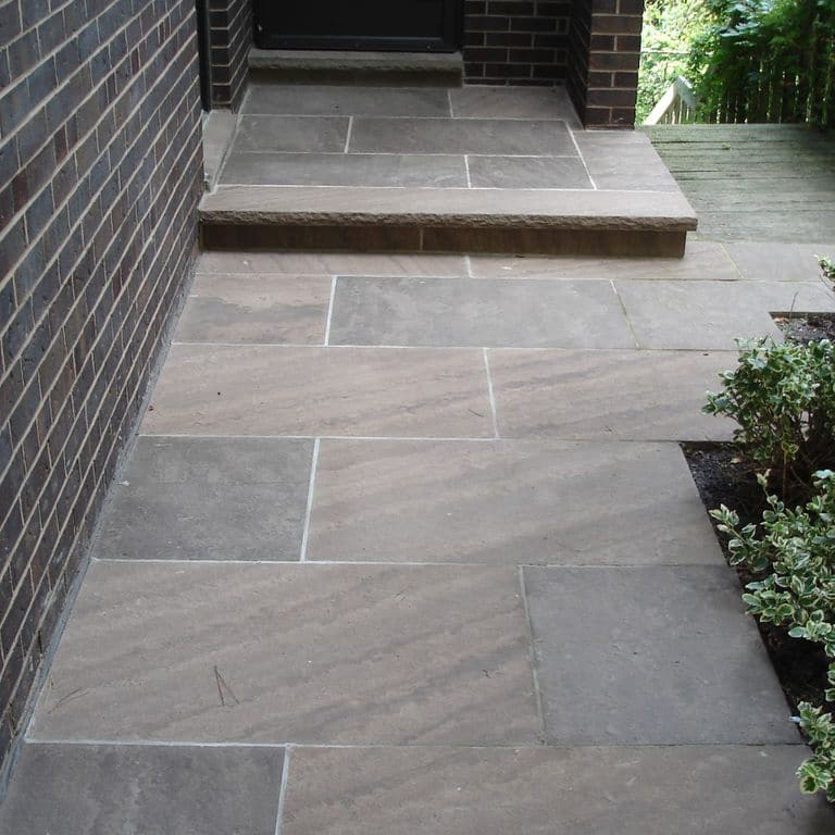 The image shows this material being used for patio pavers and treads.