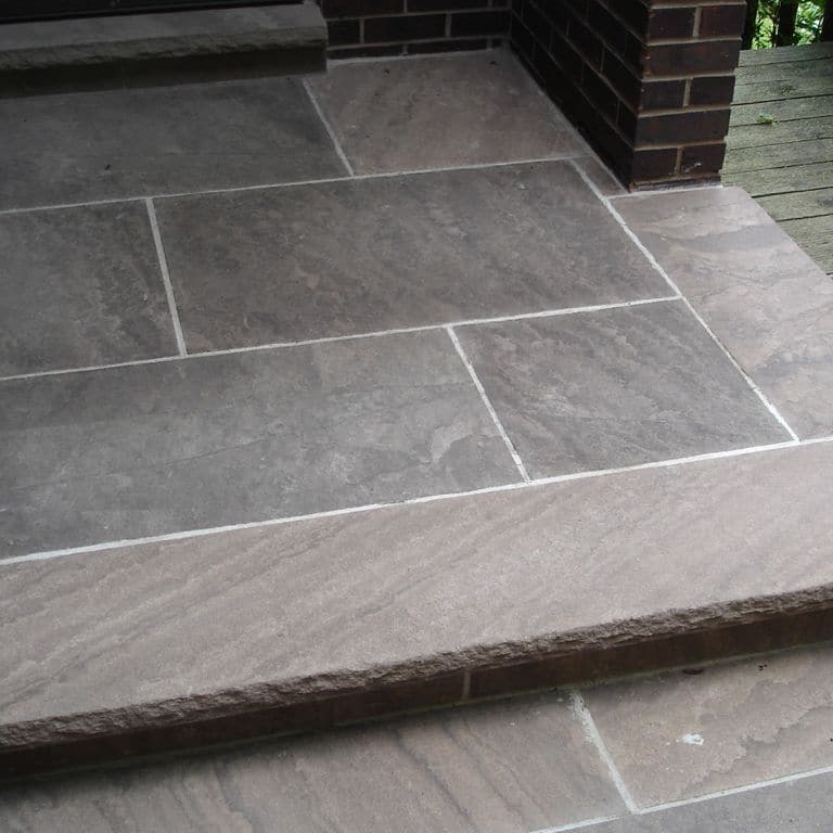 The image shows this material being used for patio pavers and treads.