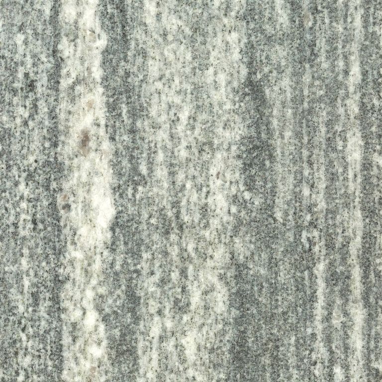 Swatch image for Granite - Galactic. The surface finish shown is honed. The dominant color shown is green; with beige, green and cream secondaries. Exhibits "movement" and the color mix creates a cool feeling. Linear and streaked color patterns. Contains mineral inclusions.