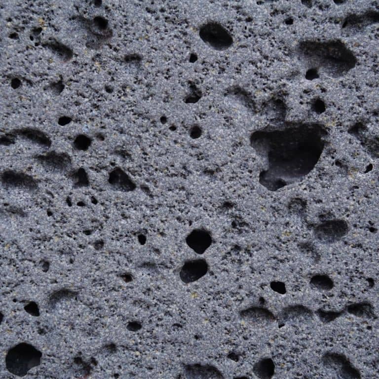 Color/Finish variation image for Ankar Lava Basalt. The surface finishes shown are sand blasted and waterjet. Dominant colors shown are blue and gray; with black and purple secondaries. The color mix creates a cool feeling. Regular color pattern.